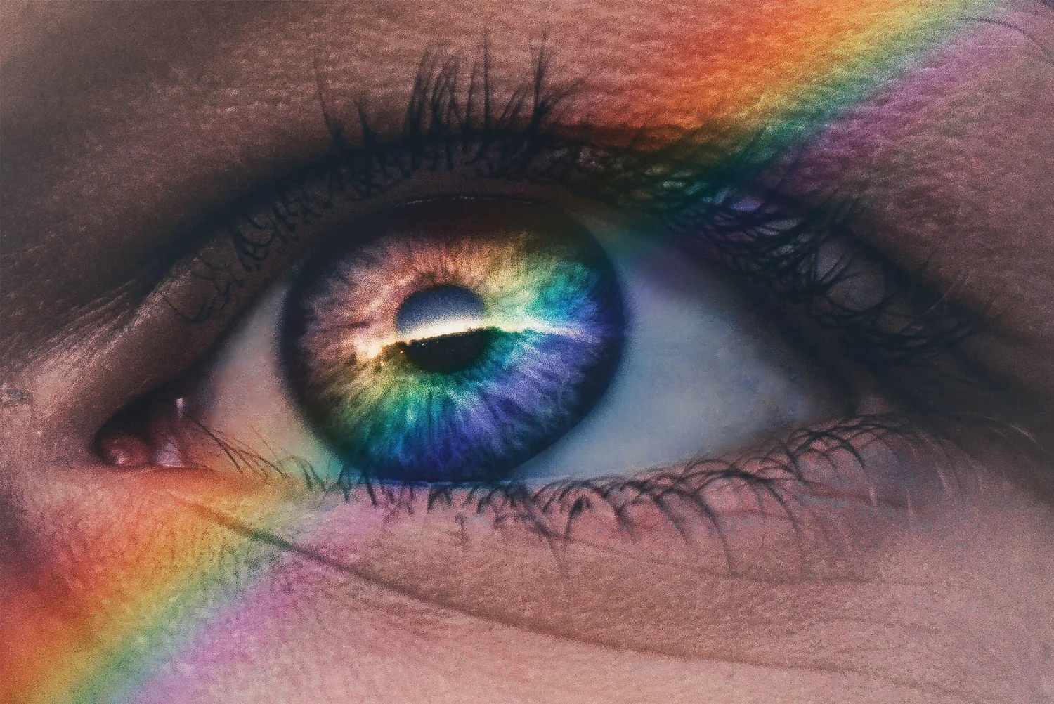 Macro photograph of an eye with rainbow prism light across the iris
